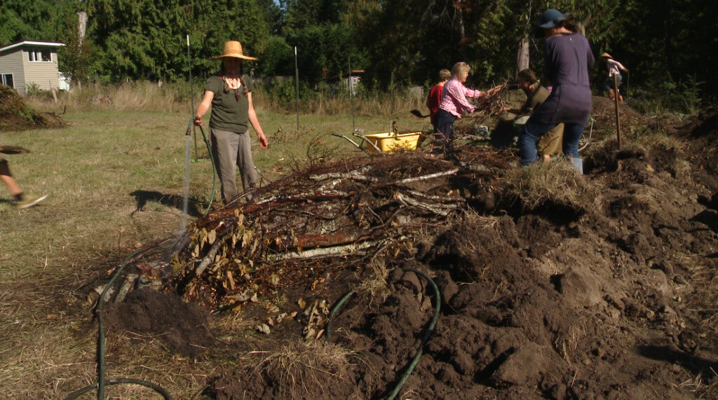 Watering the wood and filling holes maximizes soil-building capacity.
